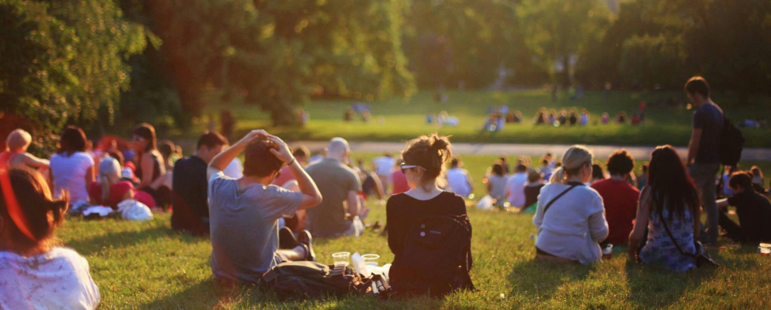 People sitting on blankets in a park