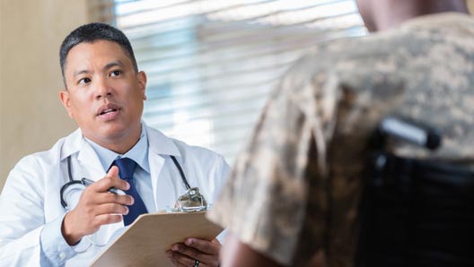 Mental health care provider speaking with client in a wheelchair